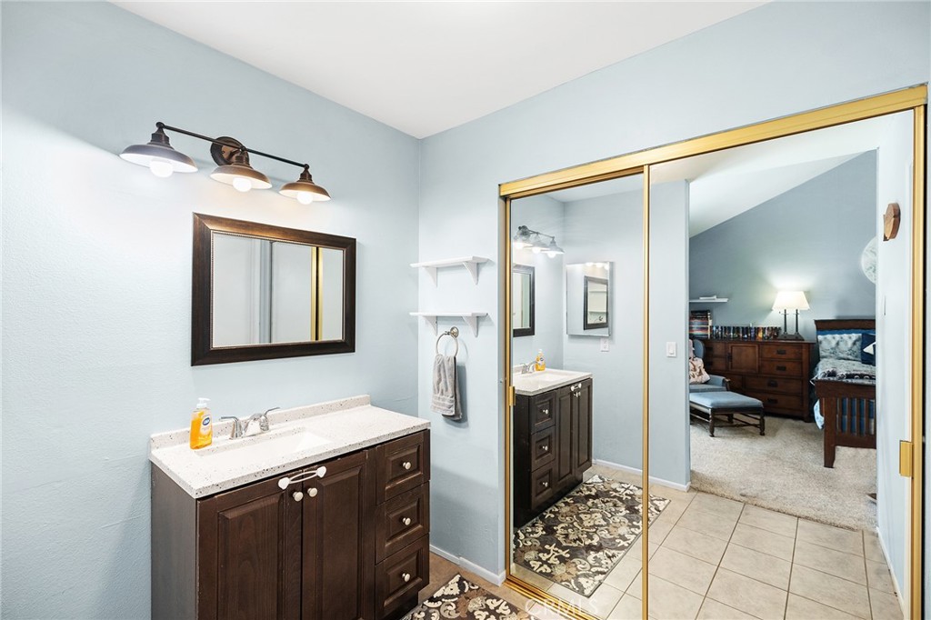 29951 Cactus Place Temecula, CA 92592 - Photo 18 of 46 a bathroom with a sink a mirror and a shower