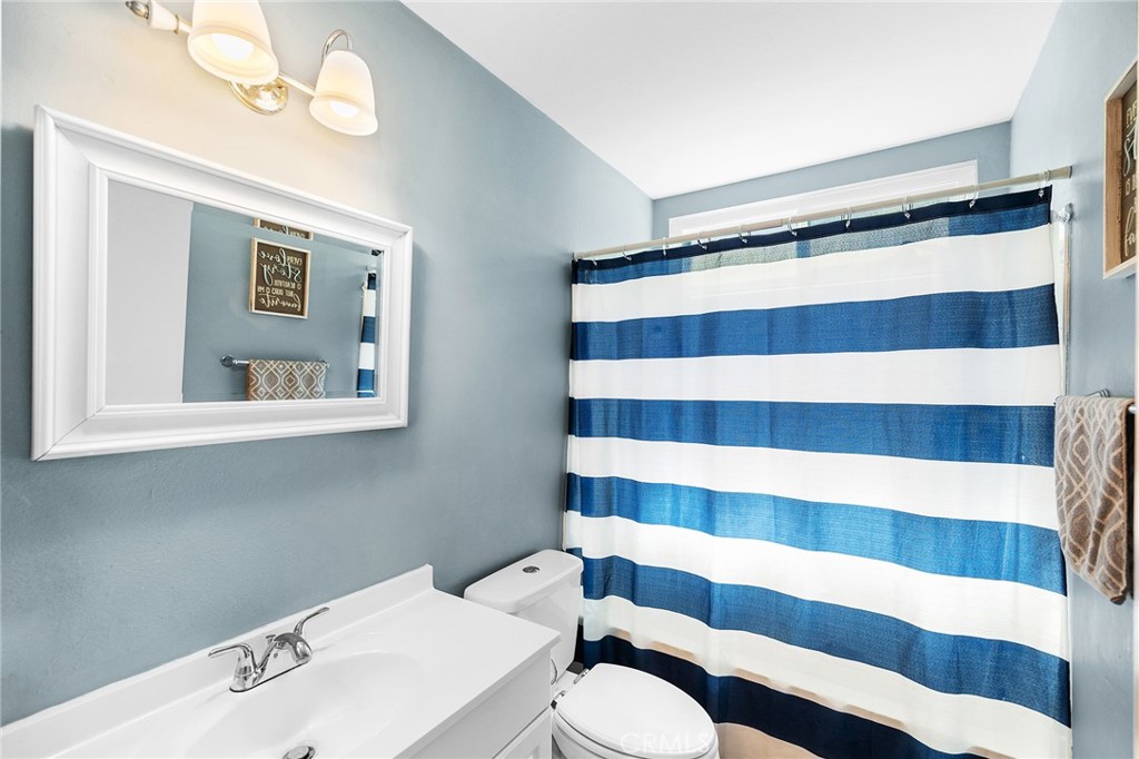 29951 Cactus Place Temecula, CA 92592 - Photo 19 of 46 a bathroom with a sink a toilet and a mirror