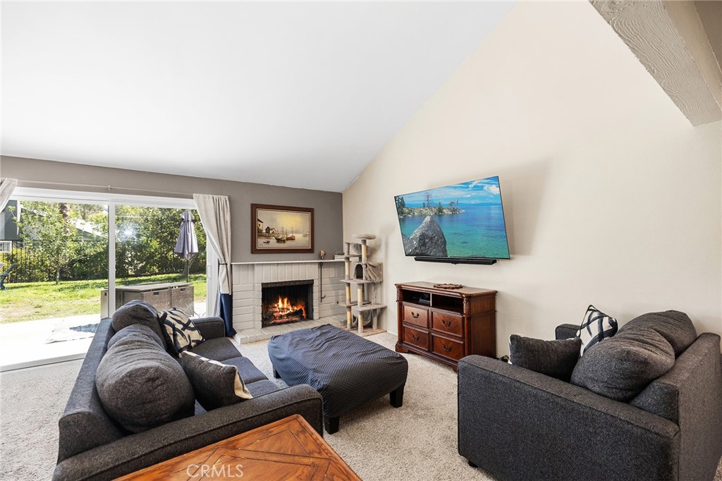 29951 Cactus Place Temecula, CA 92592 - Photo 8 of 46 a living room with furniture a fireplace and a flat screen tv