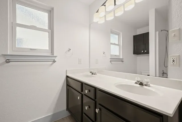 a bathroom with a sink a vanity and a mirror
