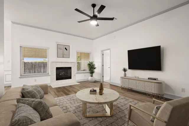 a living room with furniture a fireplace and a flat screen tv