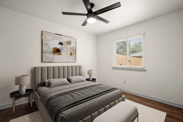 a bedroom with a bed and a painting on the wall