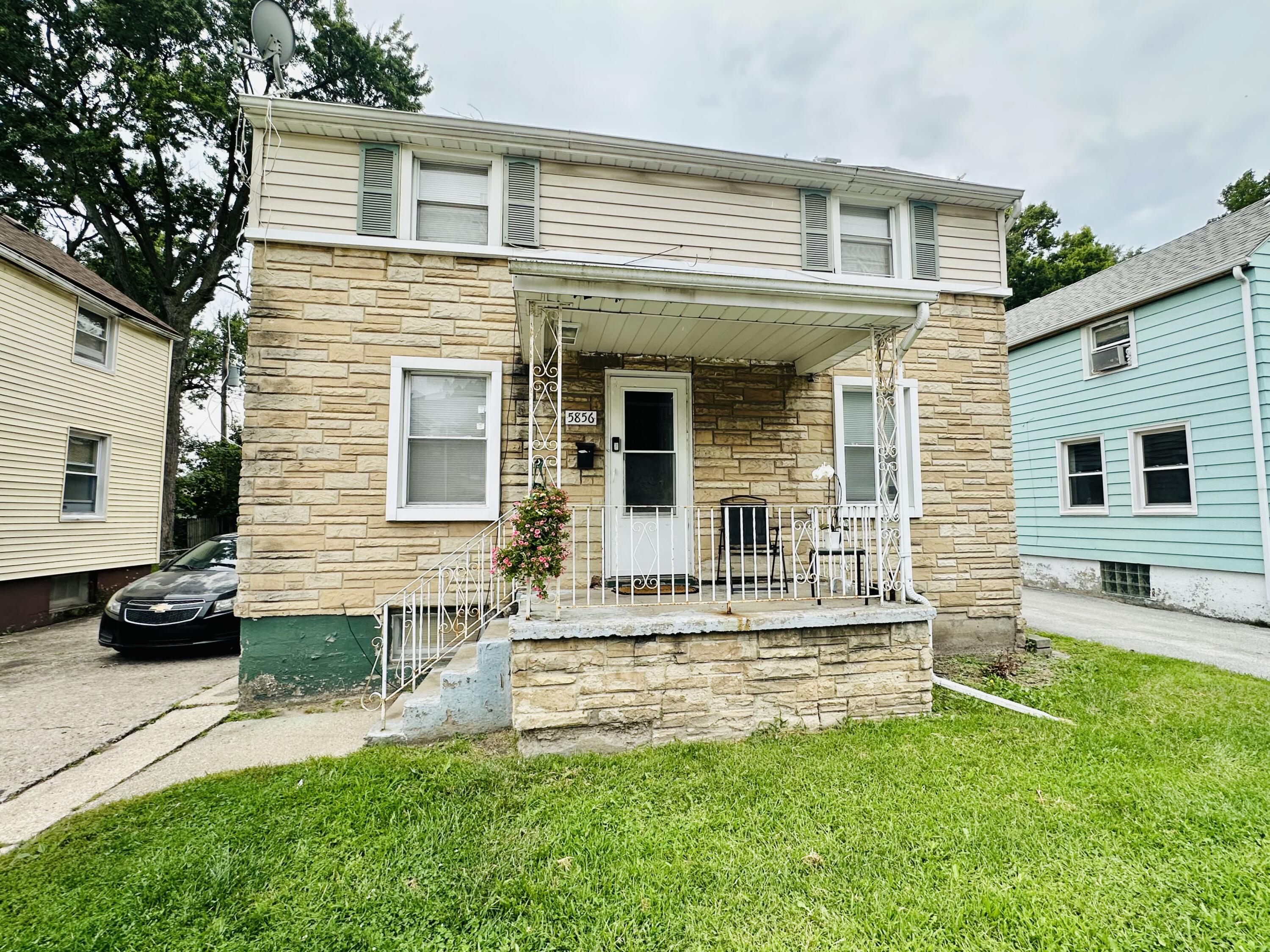 5856 Wallace Road Hammond, IN 46320 - Photo 1 of 14 a front view of a house with a yard