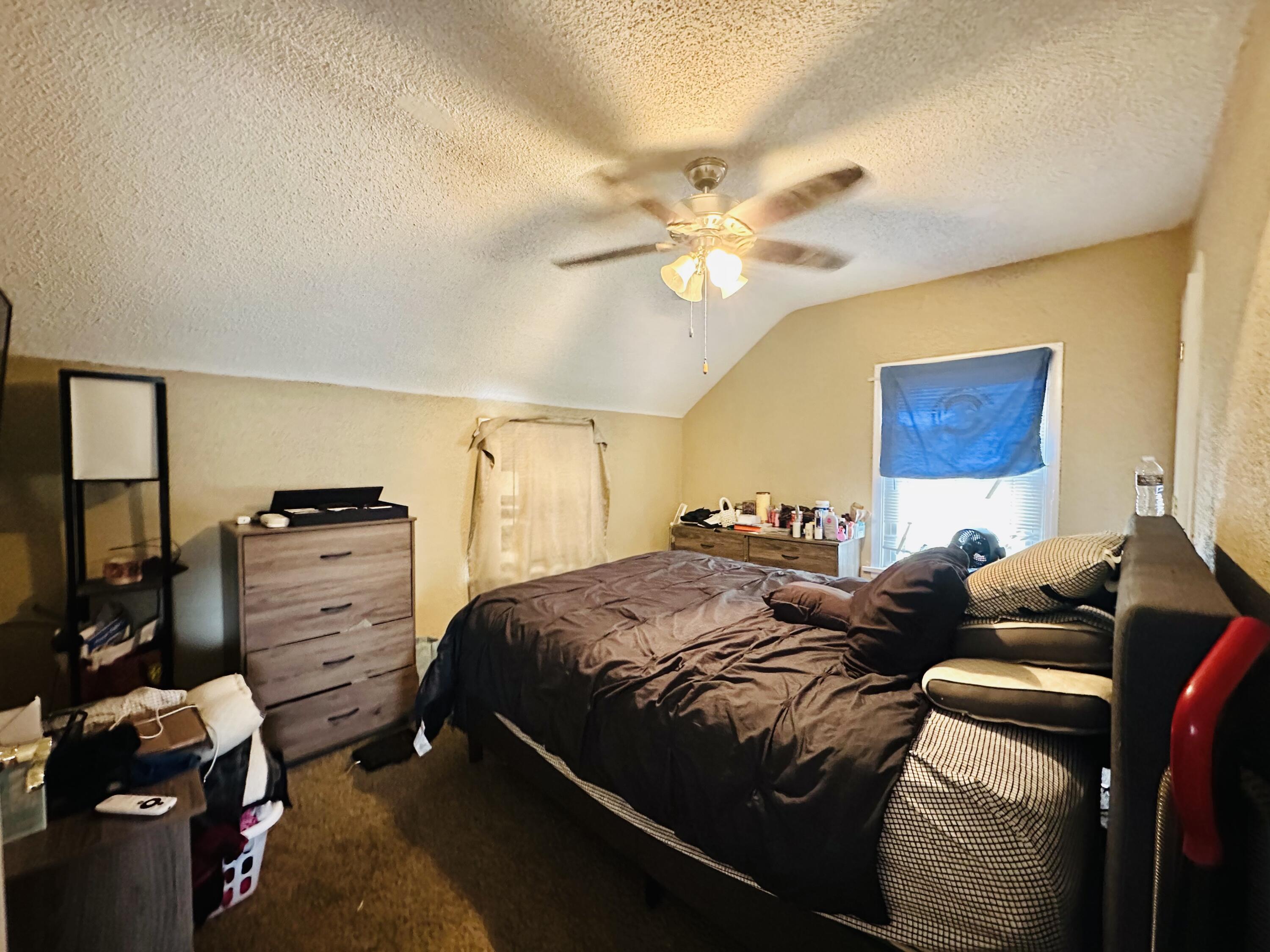 5856 Wallace Road Hammond, IN 46320 - Photo 9 of 14 a bedroom with a bed and a chandelier