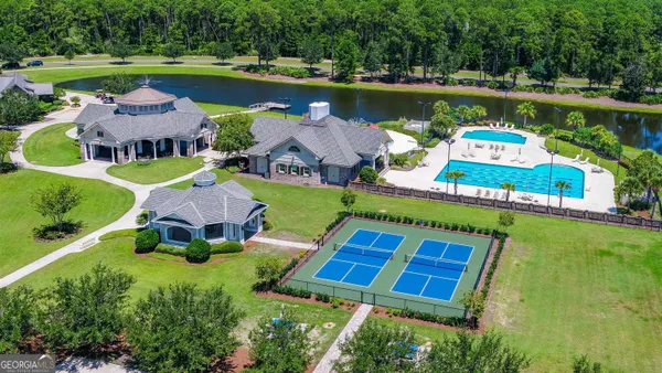an aerial view of a house with outdoor space swimming pool and lake view