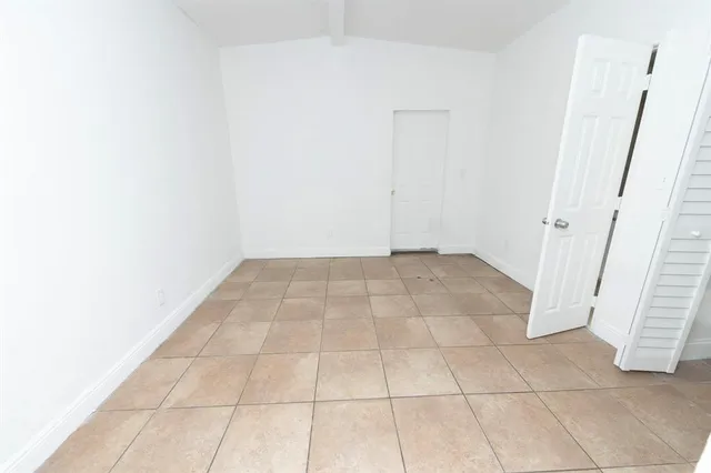 a kitchen with kitchen island granite countertop a sink stove and cabinets