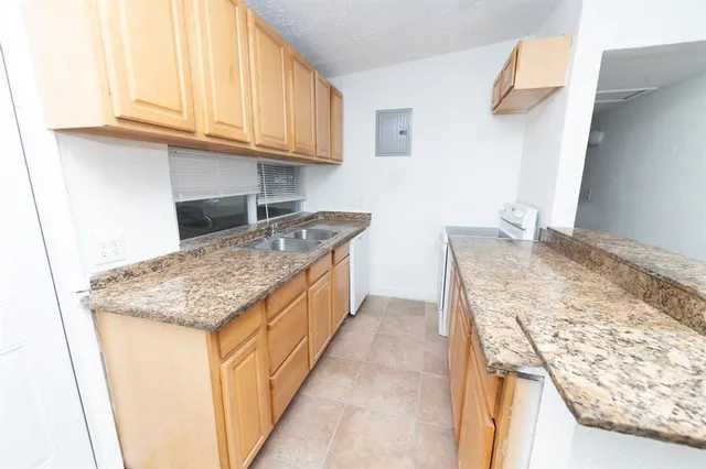 a spacious bathroom with a granite countertop sink