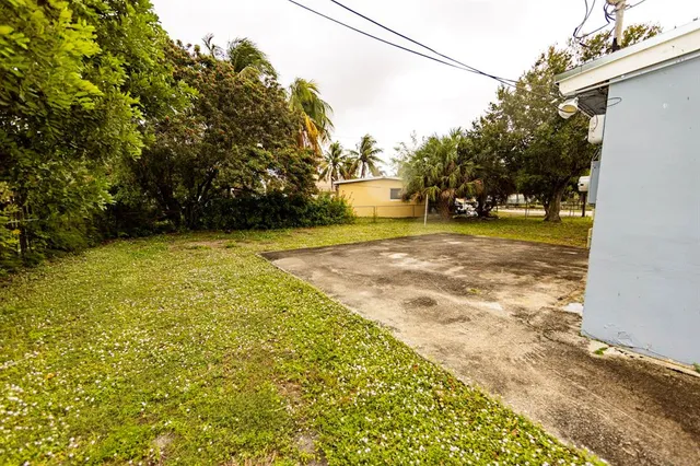 a view of a yard with a house and trees