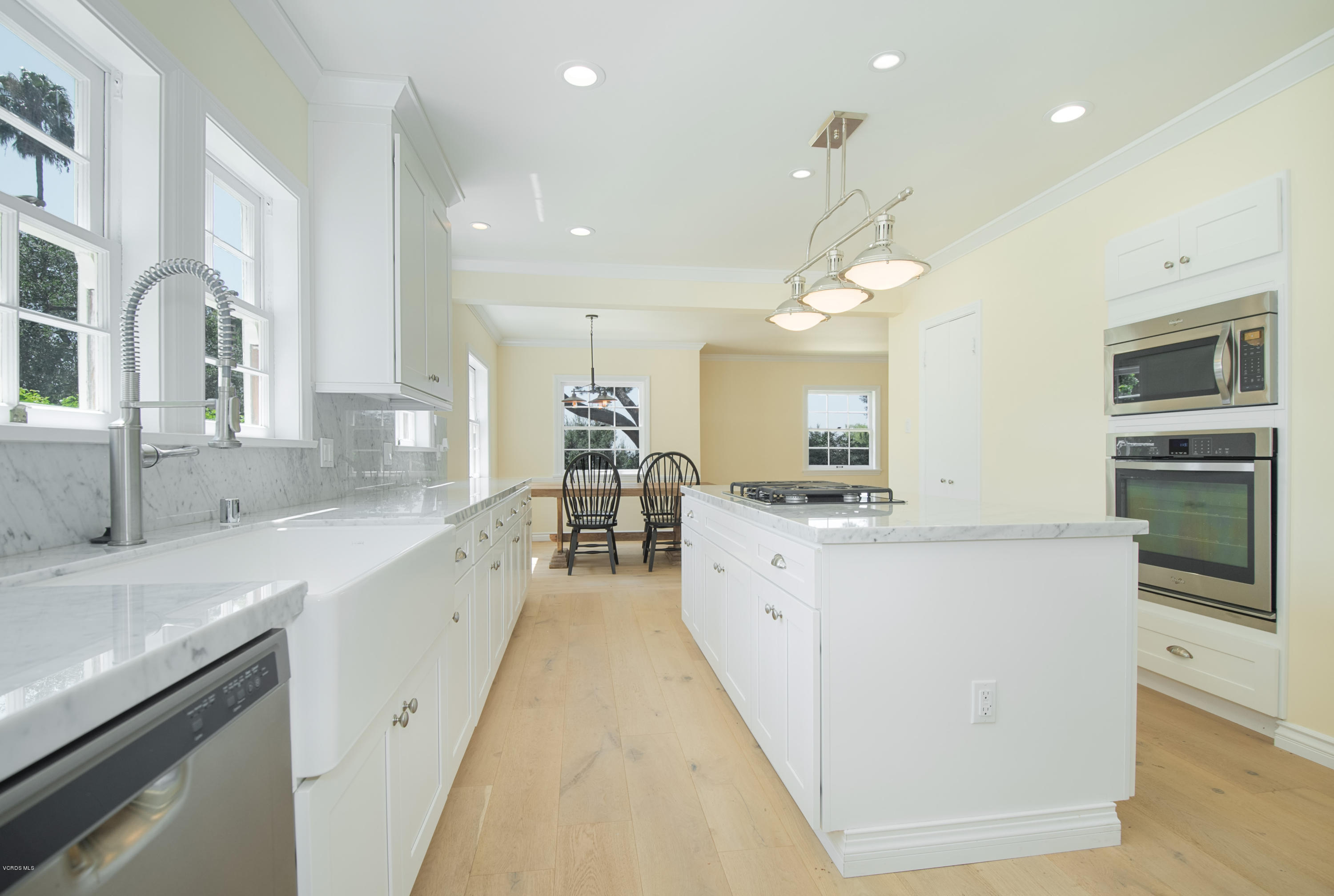 1447 Edgecliff Lane Pasadena, CA 91107 - Photo 15 of 33 a large white kitchen with a large counter top appliances and cabinets
