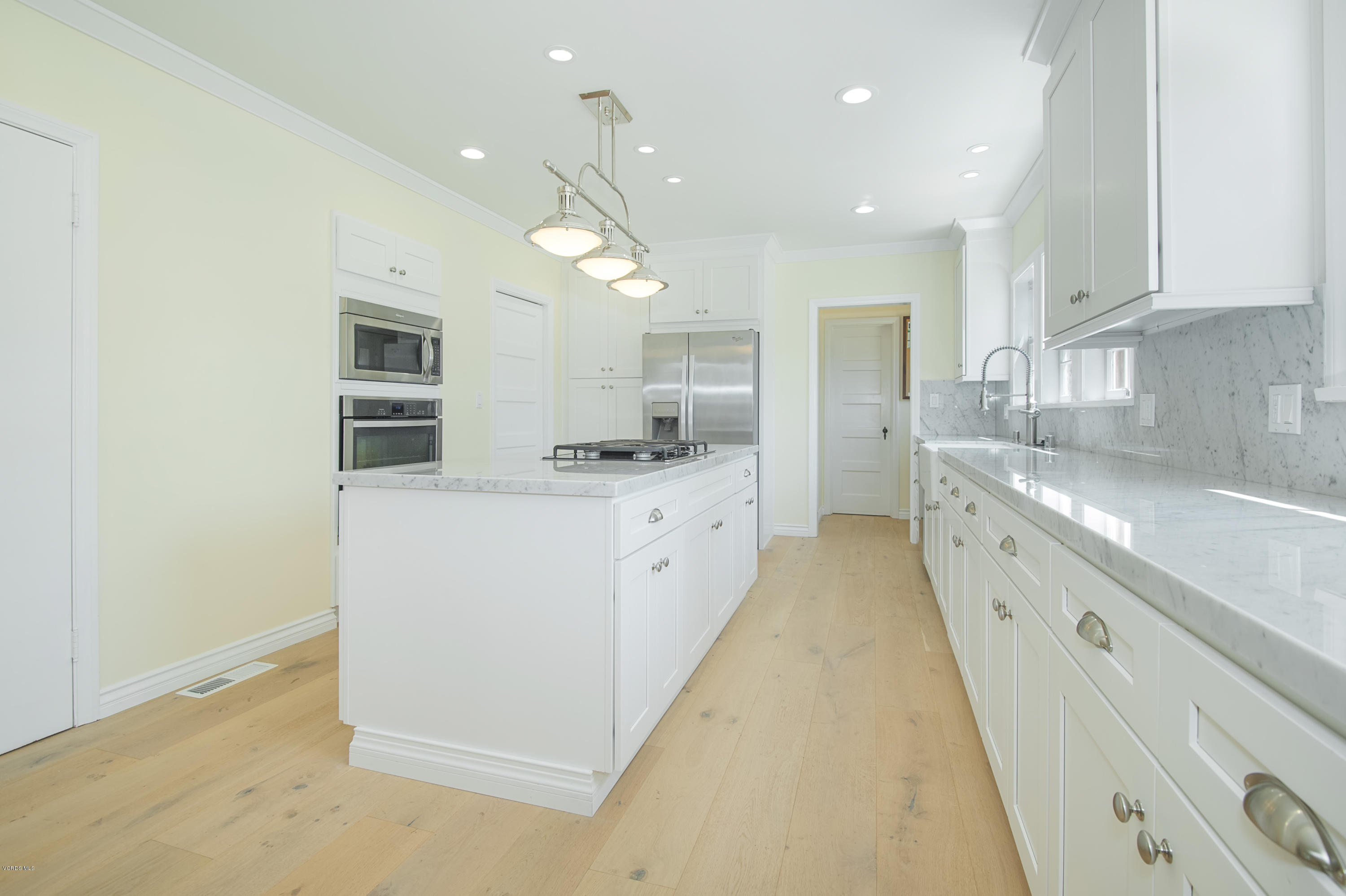 1447 Edgecliff Lane Pasadena, CA 91107 - Photo 16 of 33 a large white kitchen with a stove top oven a sink and dishwasher