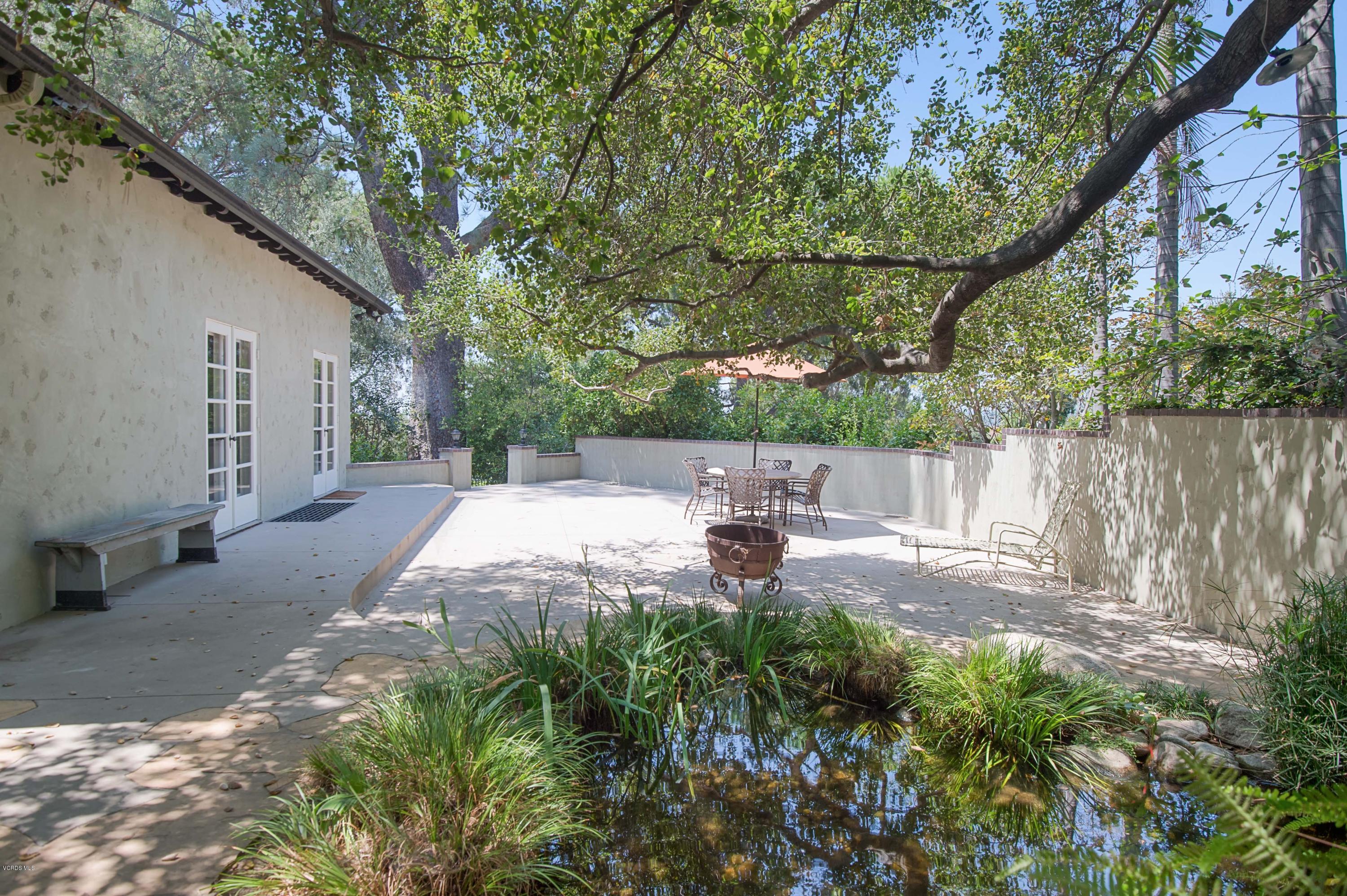 1447 Edgecliff Lane Pasadena, CA 91107 - Photo 8 of 33 a view of a backyard with table and chairs and a large tree