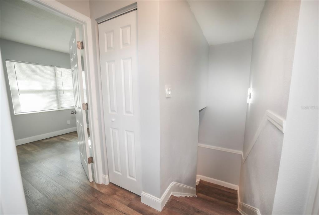 331 Amherst Avenue, Unit 56 Sarasota, FL 34232 - Photo 11 of 19 a view of wooden floor and closet in a small room
