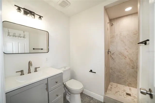 a bathroom with a toilet sink and shower