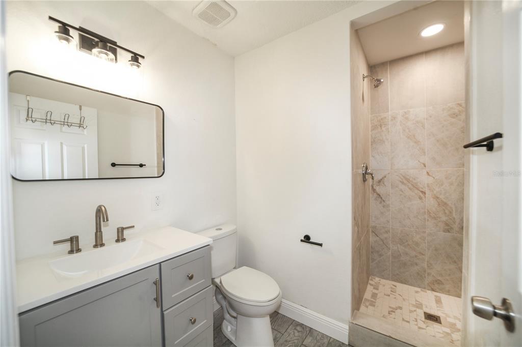 331 Amherst Avenue, Unit 56 Sarasota, FL 34232 - Photo 15 of 19 a bathroom with a toilet sink and shower