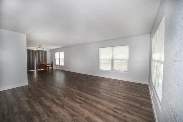a view of a room window and wooden floor