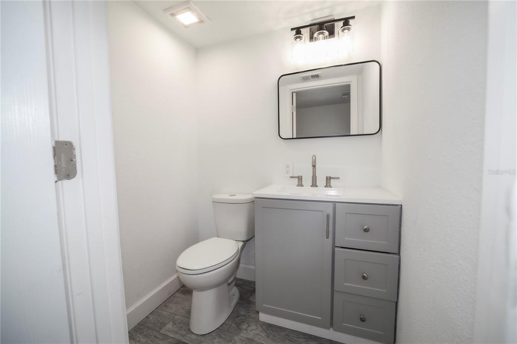 331 Amherst Avenue, Unit 56 Sarasota, FL 34232 - Photo 9 of 19 a bathroom with a toilet sink and mirror