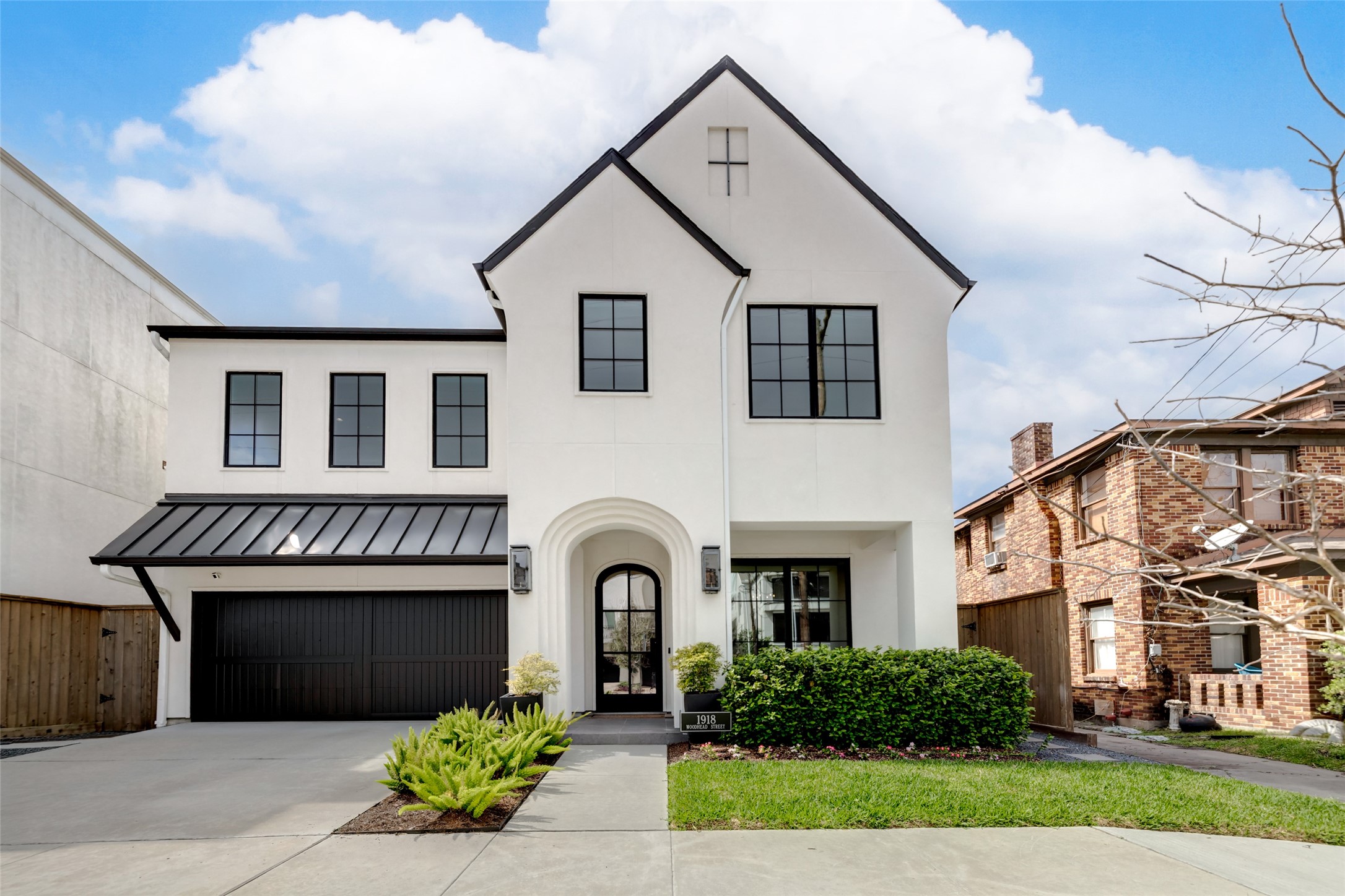 1918 Woodhead Street Houston, TX 77019 - Photo 1 of 49 a front view of a house with a garden