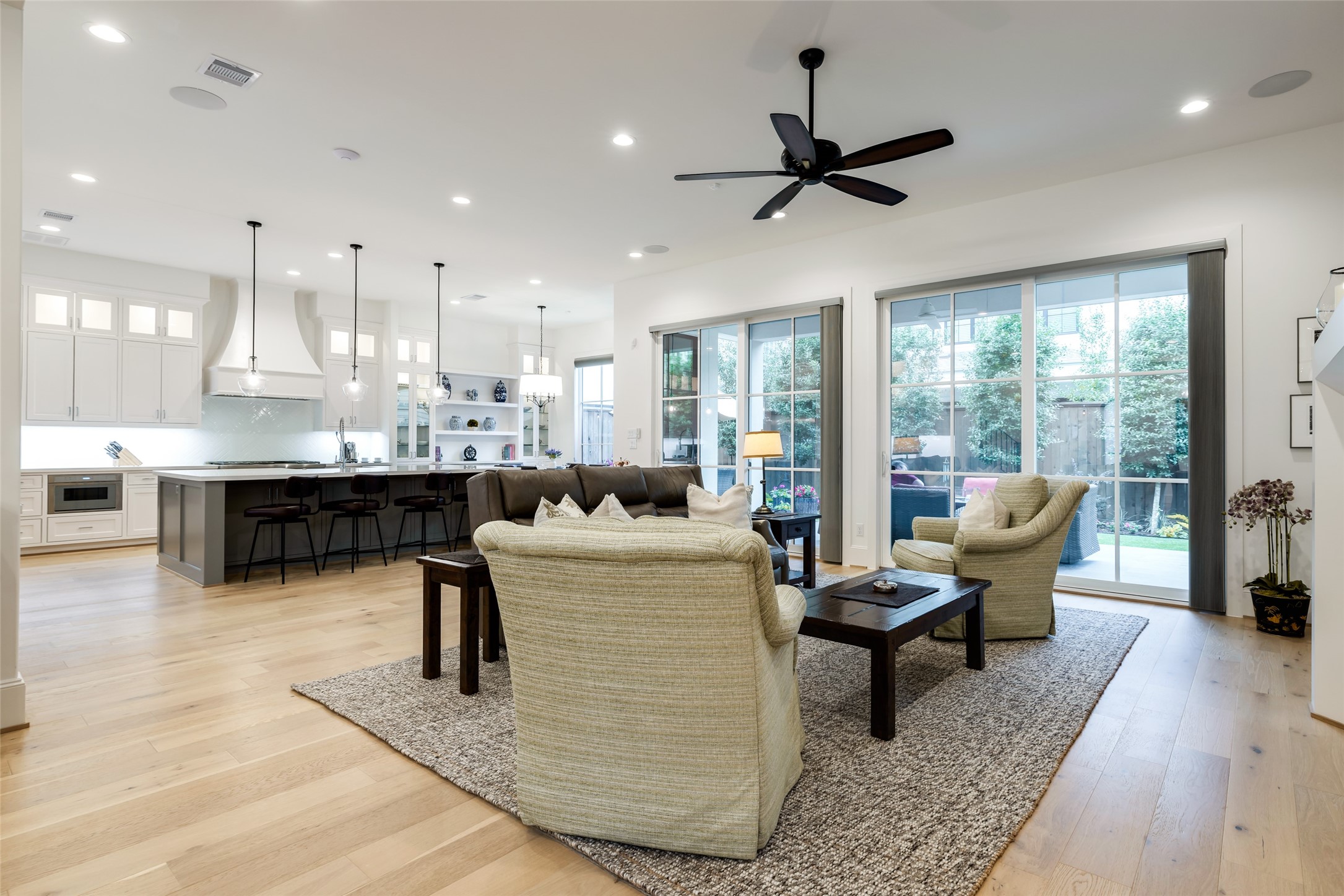1918 Woodhead Street Houston, TX 77019 - Photo 16 of 49 a living room with couches and kitchen view with wooden floor