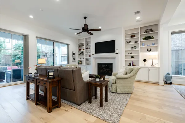 a living room with furniture a fireplace and a flat screen tv