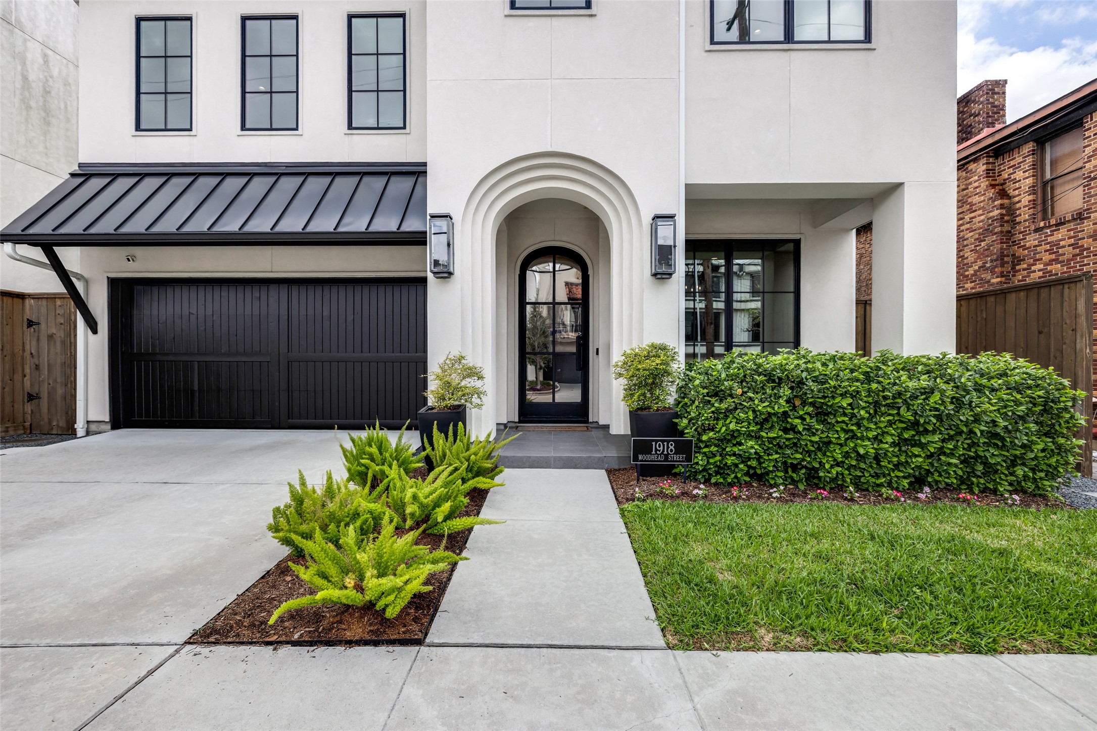1918 Woodhead Street Houston, TX 77019 - Photo 2 of 49 a front view of a house with garden