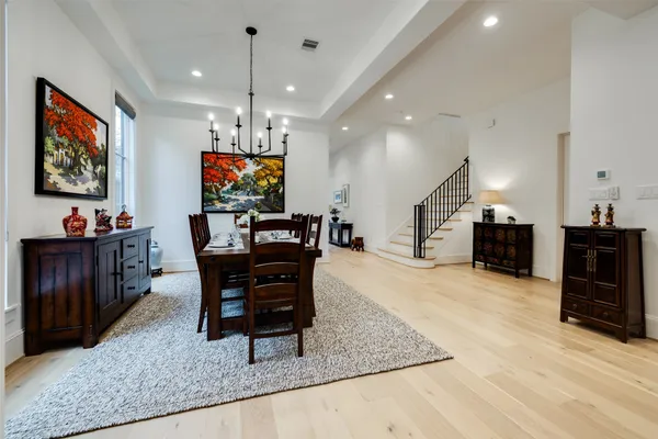 a living room with furniture a dining table and a piano table