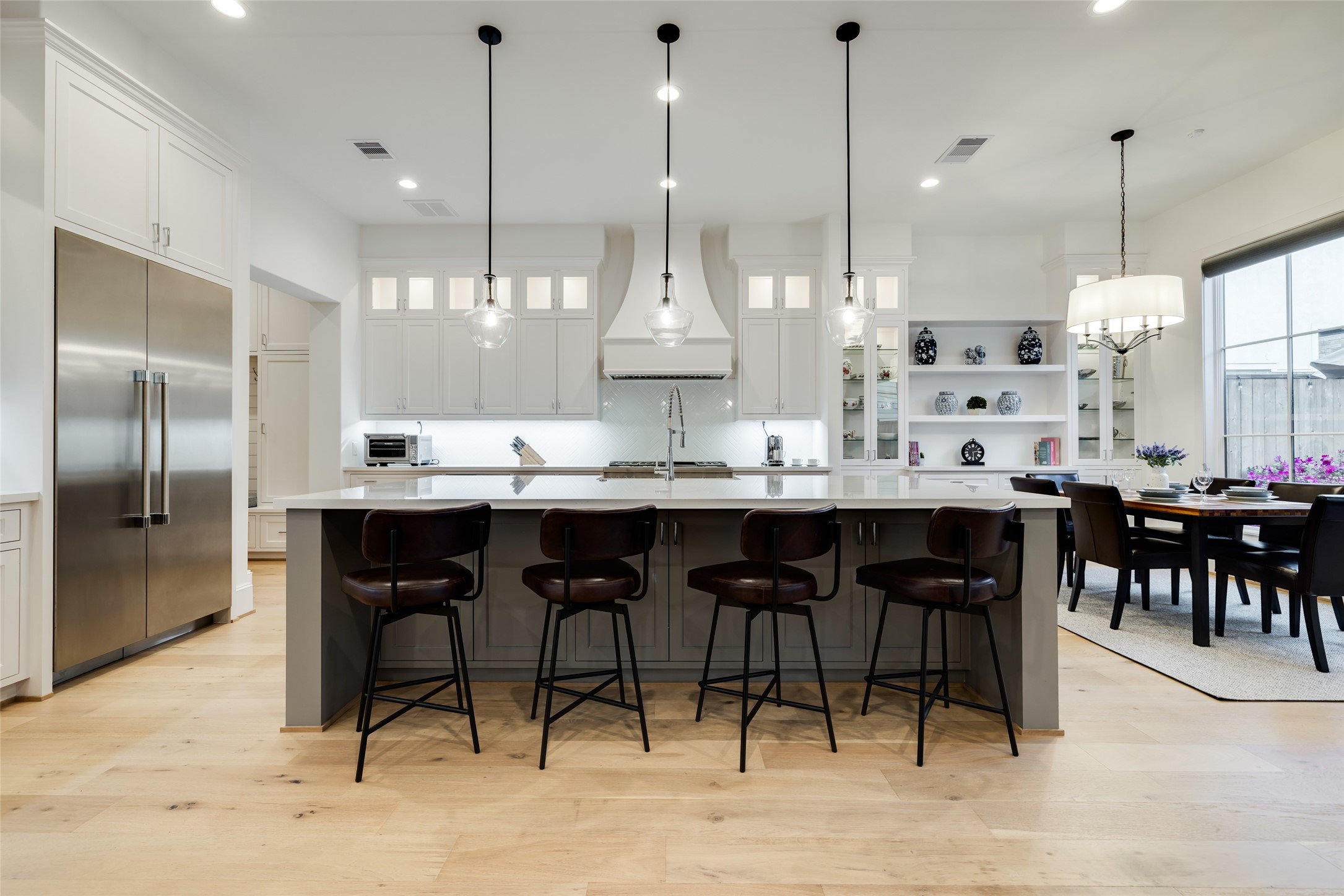 1918 Woodhead Street Houston, TX 77019 - Photo 23 of 49 a kitchen with stainless steel appliances kitchen island granite countertop a table chairs sink and cabinets