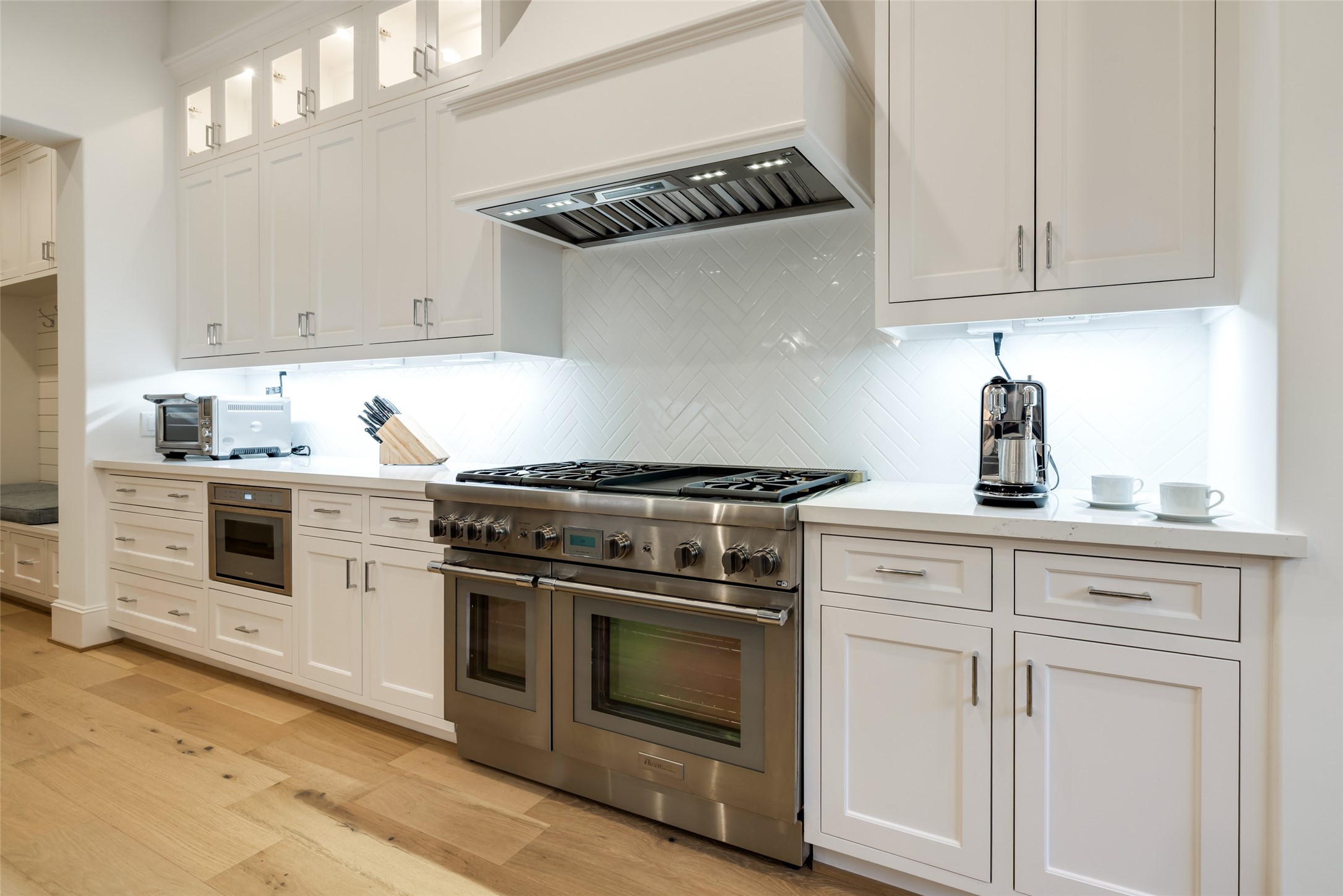 1918 Woodhead Street Houston, TX 77019 - Photo 29 of 49 a kitchen with white cabinets and appliances