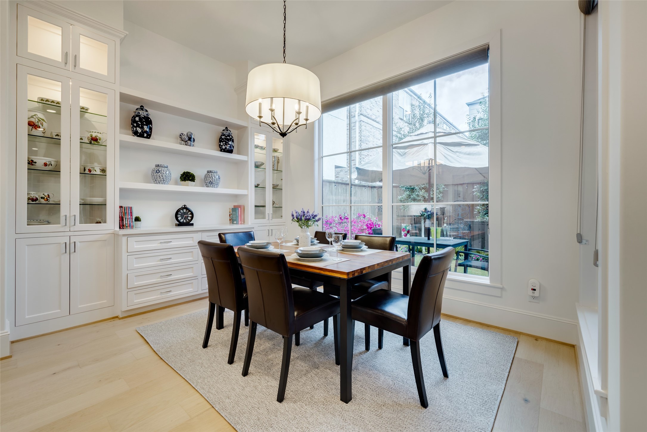 1918 Woodhead Street Houston, TX 77019 - Photo 30 of 49 a view of a dining room with furniture a chandelier and wooden floor