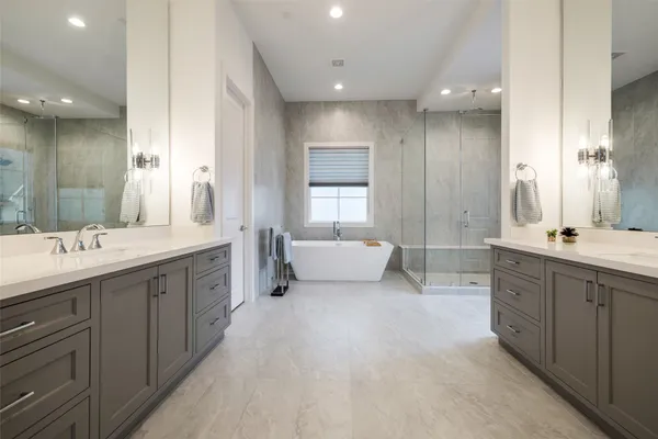 a white bath tub sitting next to a shower