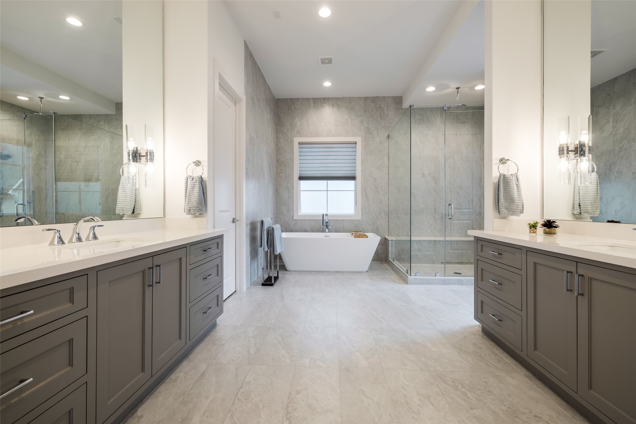 1918 Woodhead Street Houston, TX 77019 - Photo 37 of 49 a spacious bathroom with a double vanity sink large mirror and a bathtub