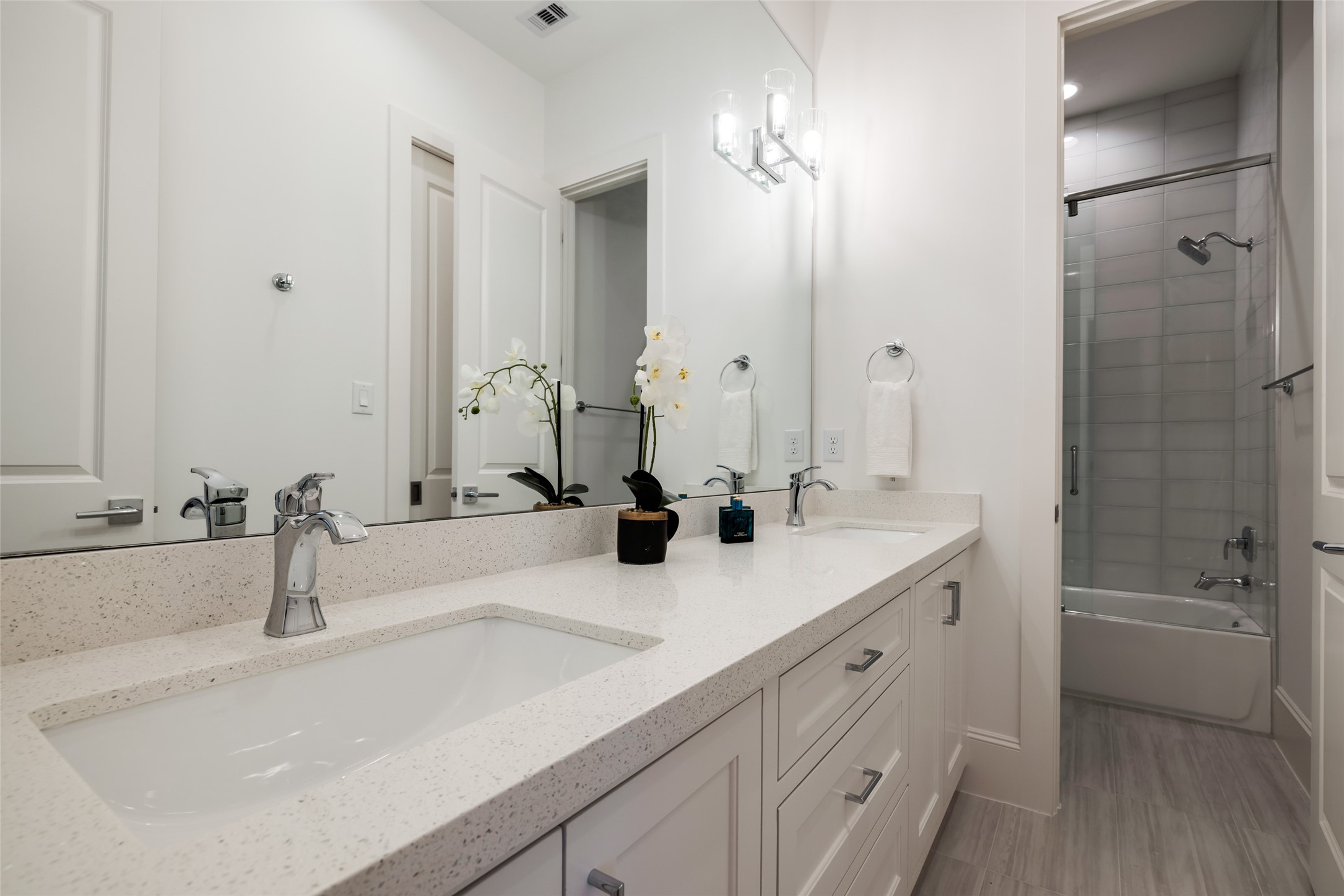 1918 Woodhead Street Houston, TX 77019 - Photo 42 of 49 a bathroom with 2 sink tub and a mirror