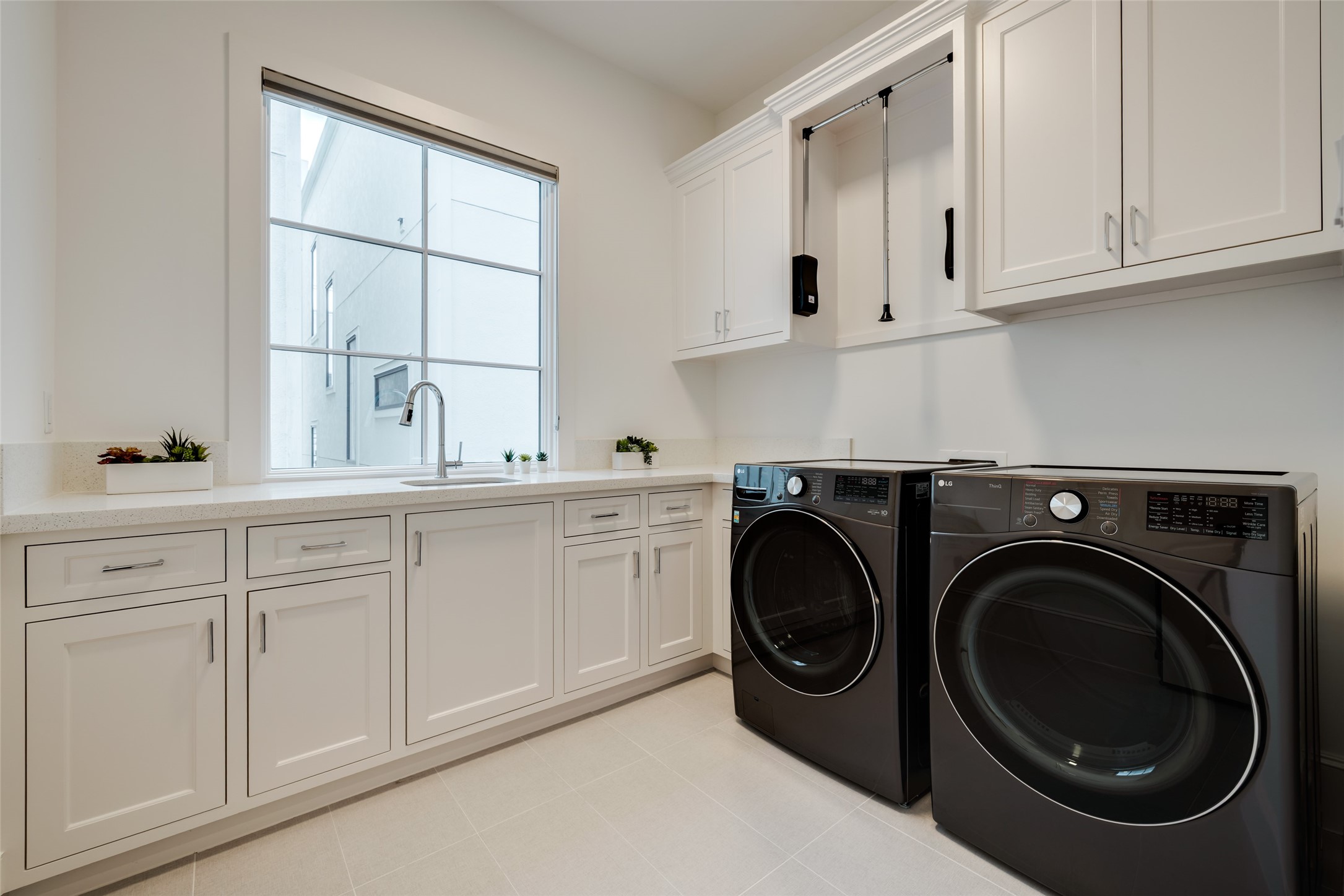 1918 Woodhead Street Houston, TX 77019 - Photo 43 of 49 a utility room with sink dryer and washer