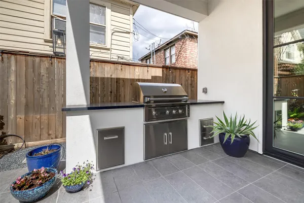 a kitchen with a refrigerator and a potted plant