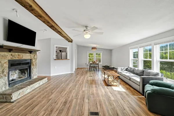 a living room with furniture fireplace and flat screen tv