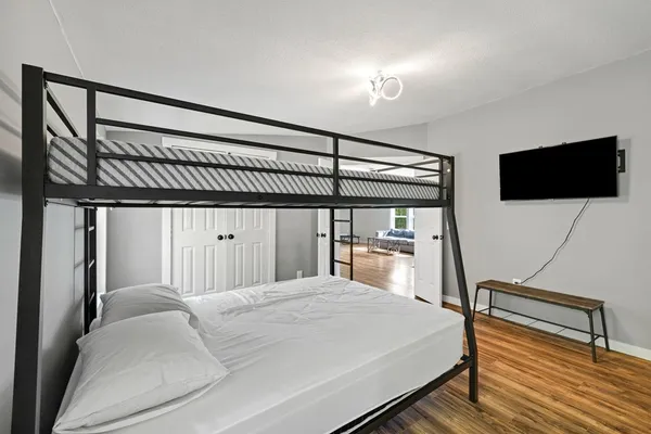 a bedroom with a bed and a flat screen tv