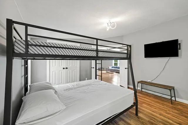 a bedroom with a bed and a flat screen tv