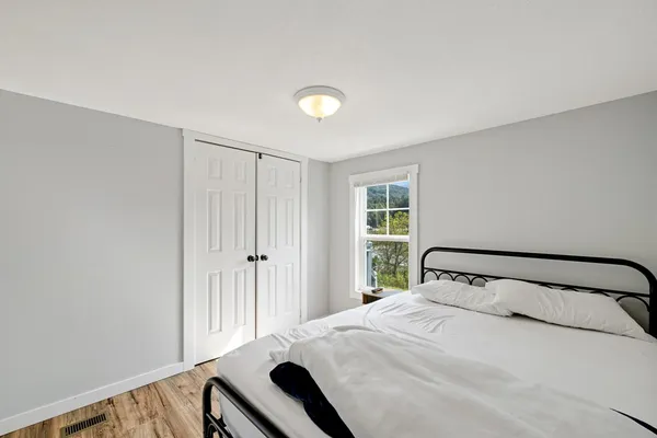 a bedroom with a bed and a window