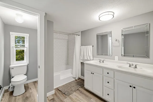 a bathroom with a toilet a sink and a mirror