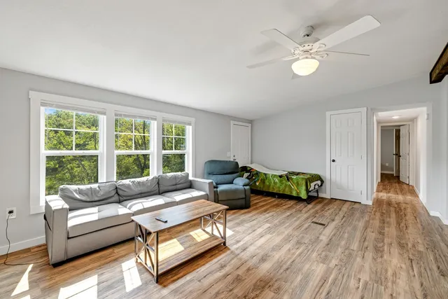 a living room with furniture and a large window