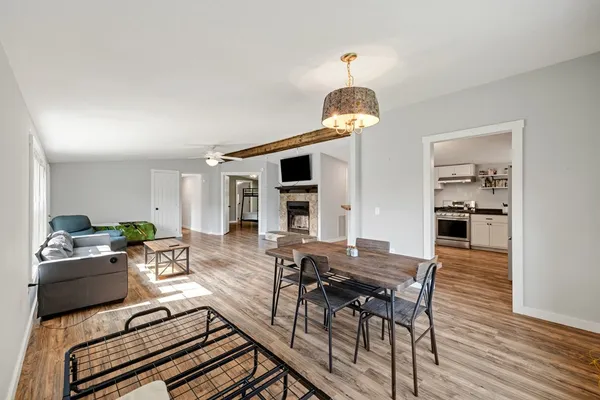 a view of a dining room with furniture wooden floor and chandelier