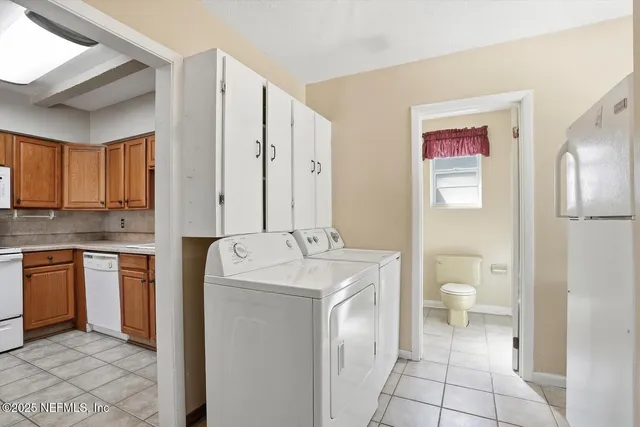 a bathroom with a granite countertop sink a toilet and a shower