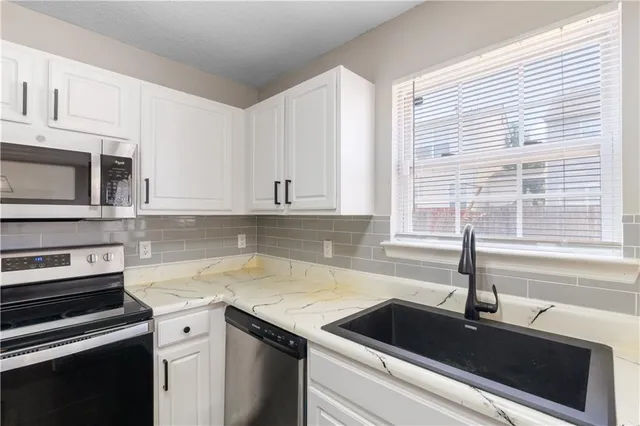 a kitchen with a sink and cabinets