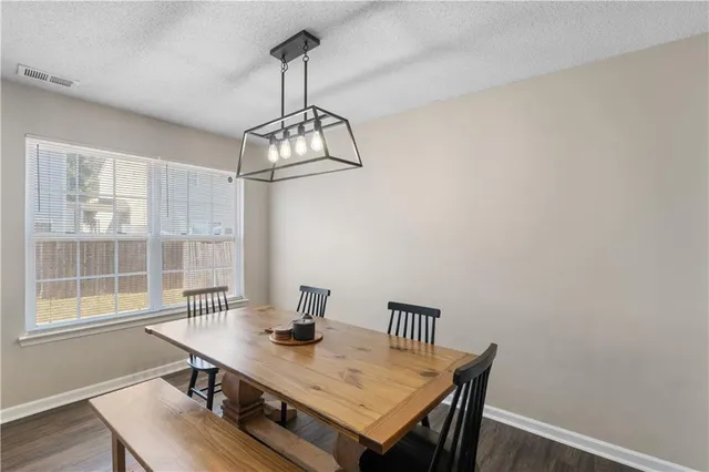 a view of a dining room with a table and chairs