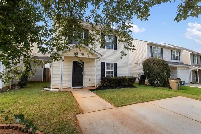 a front view of a house with a garden