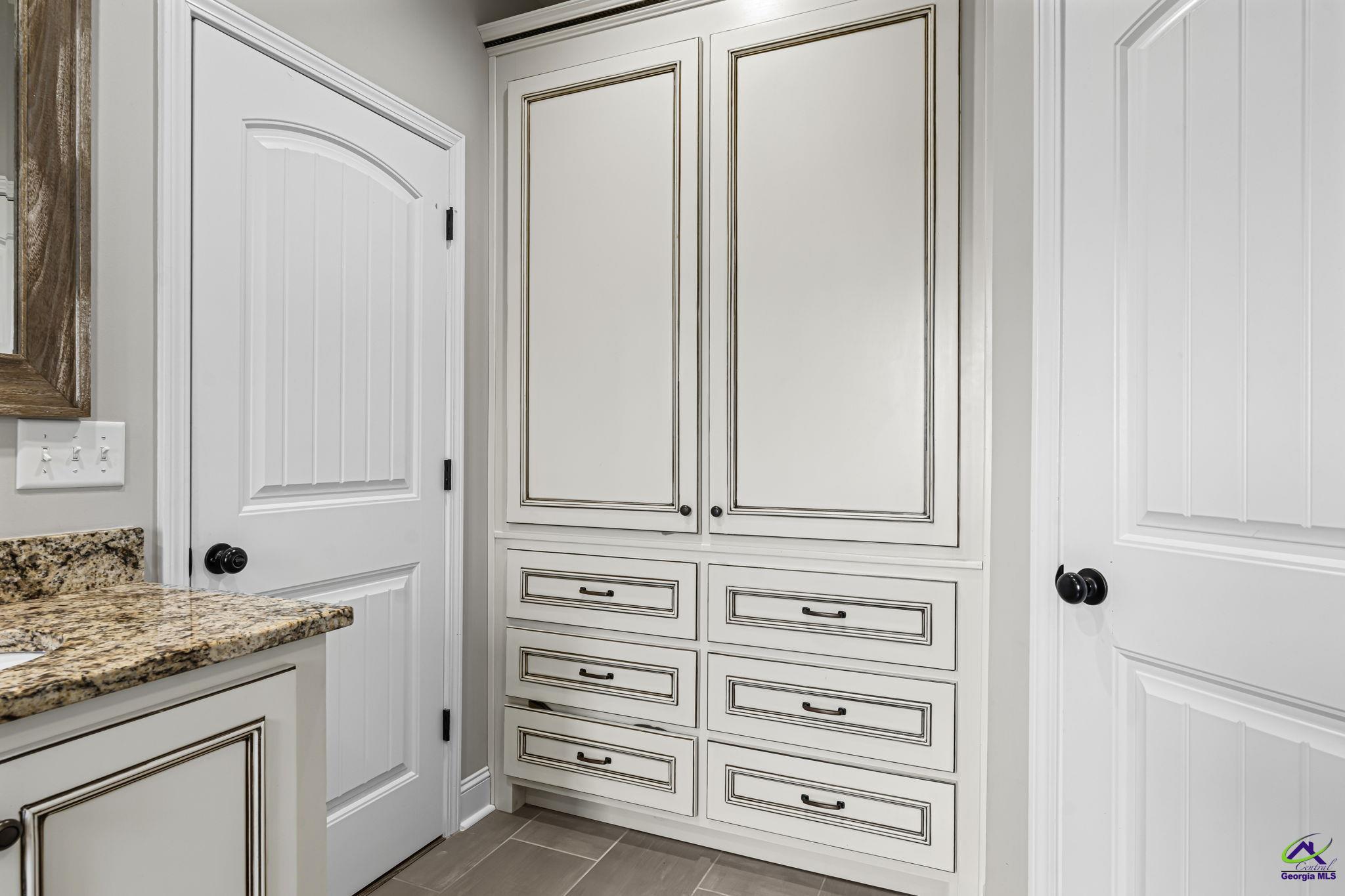180 Woodland Trail Road Cochran, GA 31014 - Photo 16 of 25 a view of bathroom with granite countertop cabinets