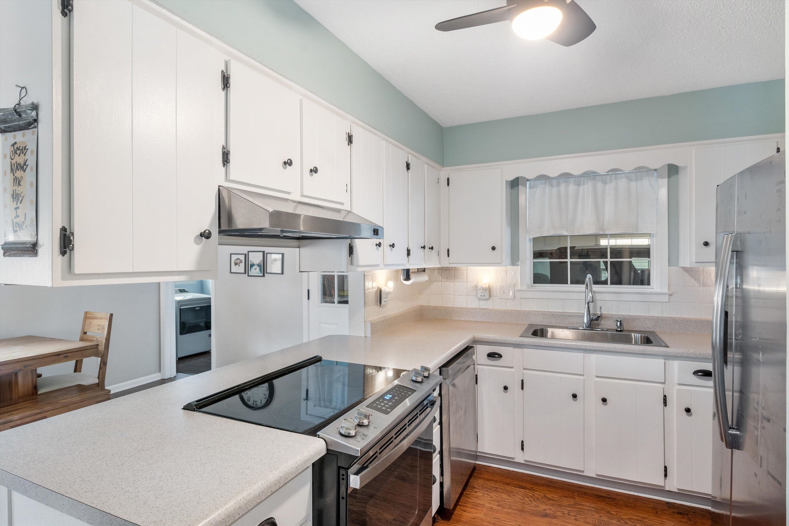 2984 Ruffle Drive Bartlett, TN 38134 - Photo 5 of 31 a kitchen with stainless steel appliances a white stove top oven a sink a refrigerator and white cabinets