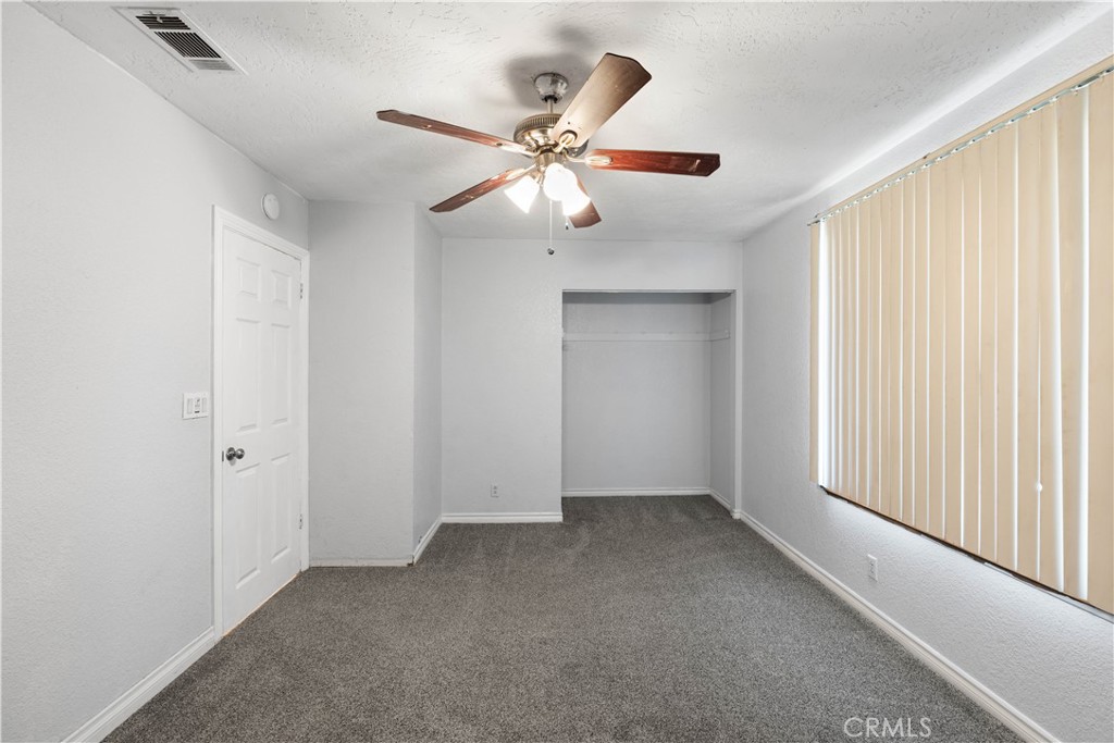 18891 Shoshonee Road Apple Valley, CA 92307 - Photo 12 of 33 wooden floor in an empty room with a window