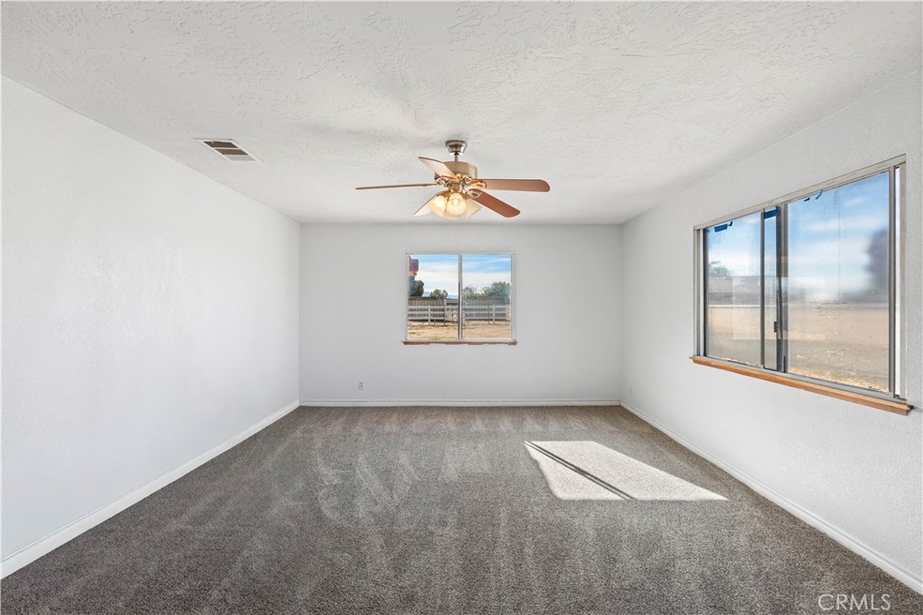 18891 Shoshonee Road Apple Valley, CA 92307 - Photo 16 of 33 wooden floor in an empty room with a window