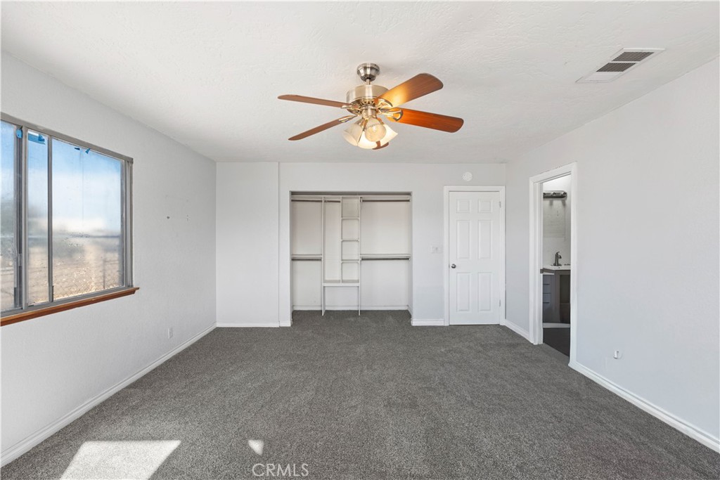18891 Shoshonee Road Apple Valley, CA 92307 - Photo 18 of 33 a view of an empty room with window and a kitchen