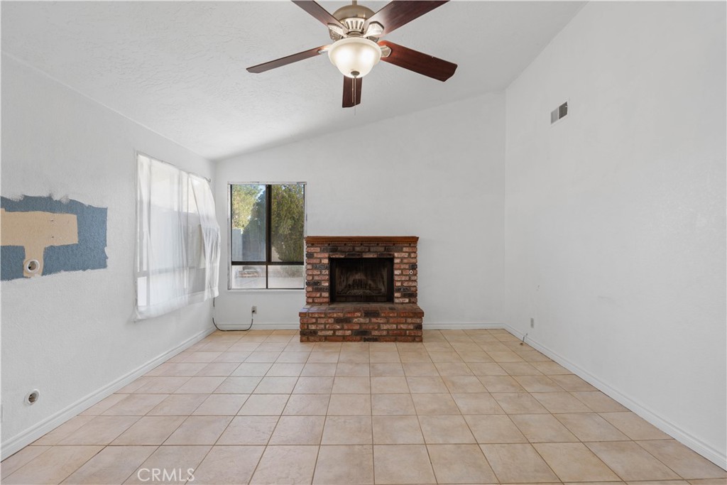 18891 Shoshonee Road Apple Valley, CA 92307 - Photo 3 of 33 a living room with furniture and a fireplace